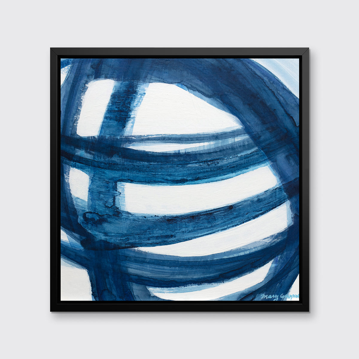 A blue and white abstract print in a black floater frame hangs on a white wall.