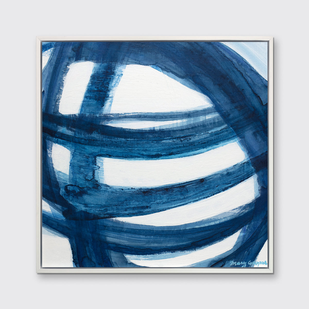A blue and white abstract print in a white floater frame hangs on a white wall.