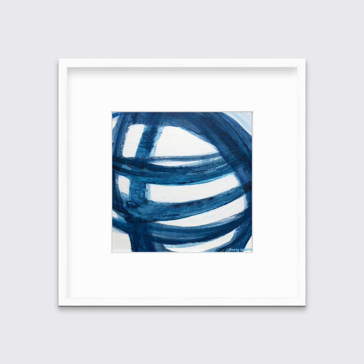 A blue and white abstract print in a white frame with a mat hangs on a white wall.