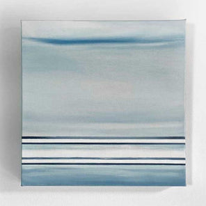 A blue and white linear abstract painting hanging on a white wall.