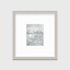 A white and grey abstract print in a silver frame with a mat hangs on a white wall.