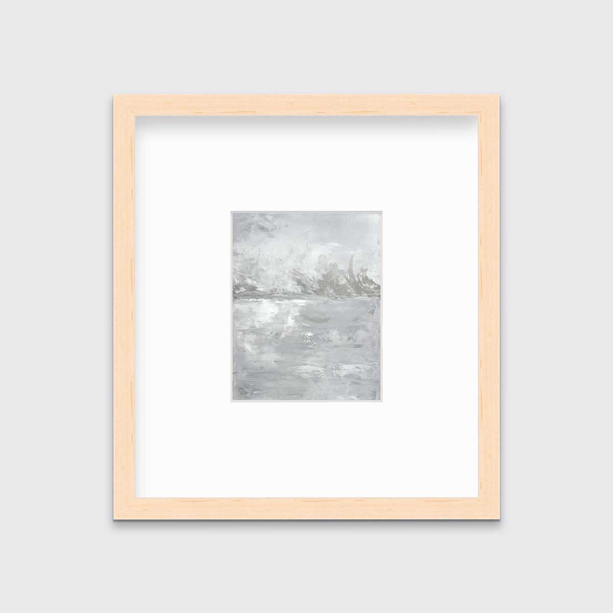 A white and grey abstract print in a natural wood frame with a mat hangs on a white wall.