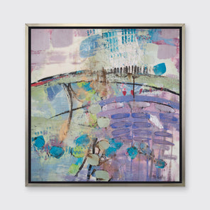 A multicolored abstract print framed in a warm silver floater frame hangs on a light grey wall.