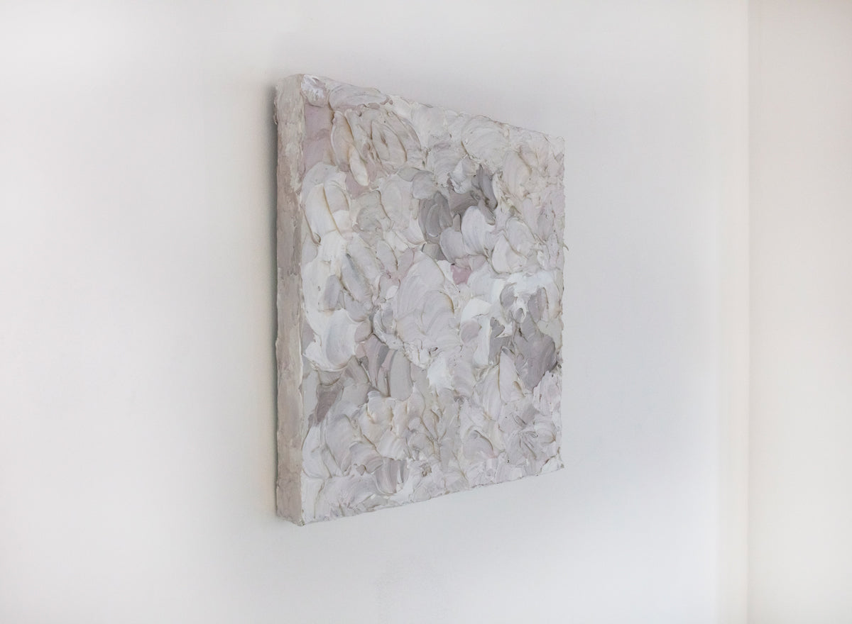 A left angle view of a small abstract painting by Teodora Guererra. It hangs on a white gallery wall.