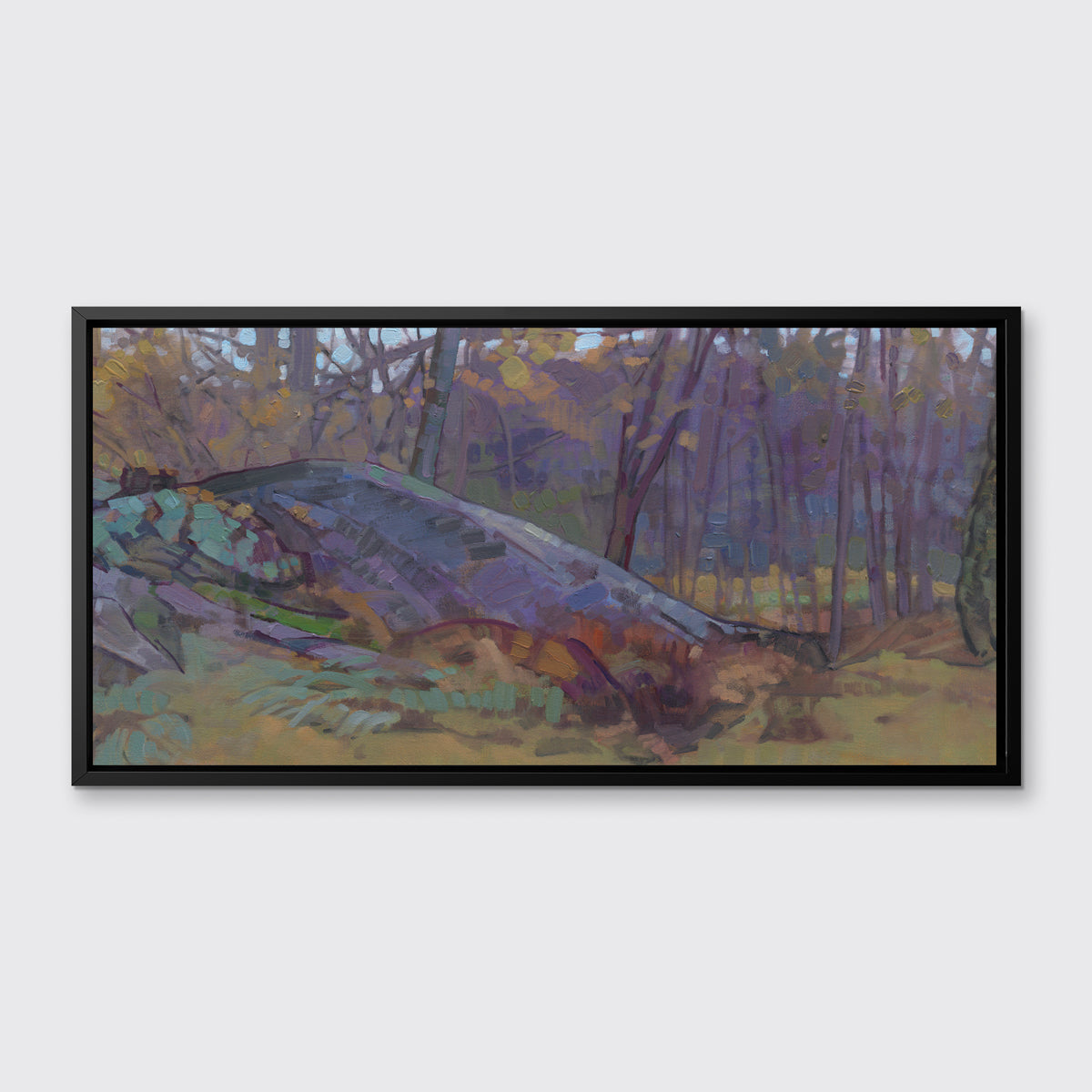 A muted multicolored abstract landscape print in a black floater frame hangs on a white wall.