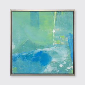 A blue, green and white abstract print in a silver floater frame hangs on a white wall.