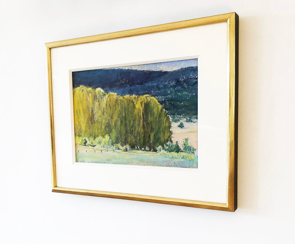 The painting, Study, Highland Greens by Ken Elliott hanging on a white wall matted in a gold frame with a view from the right. 