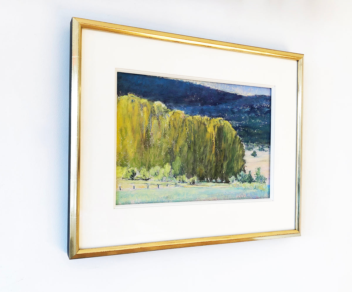 The painting, Study, Highland Greens by Ken Elliott hanging on a white wall matted in a gold frame with a view from the left.