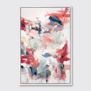 A pink, blue and white abstract print in a white floater frame hangs on a white wall.