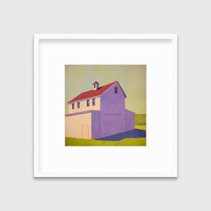 A contemporary barn print in a white frame with a mat hangs on a white wall.