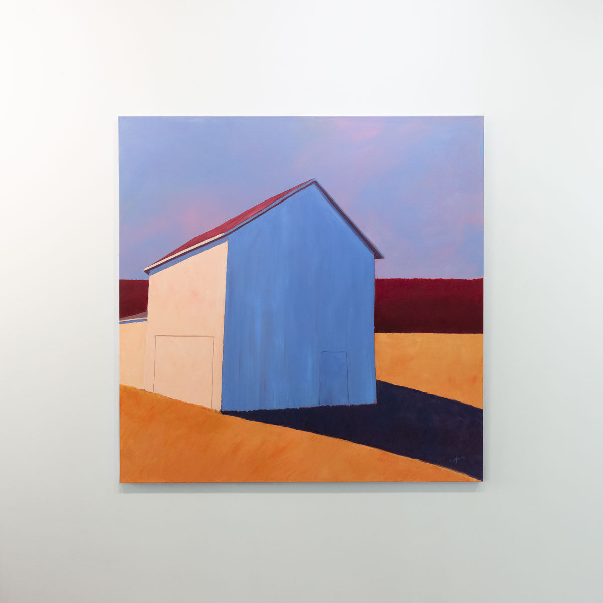 A painting of a white barn casting a long shadow is hung on a gallery wall.