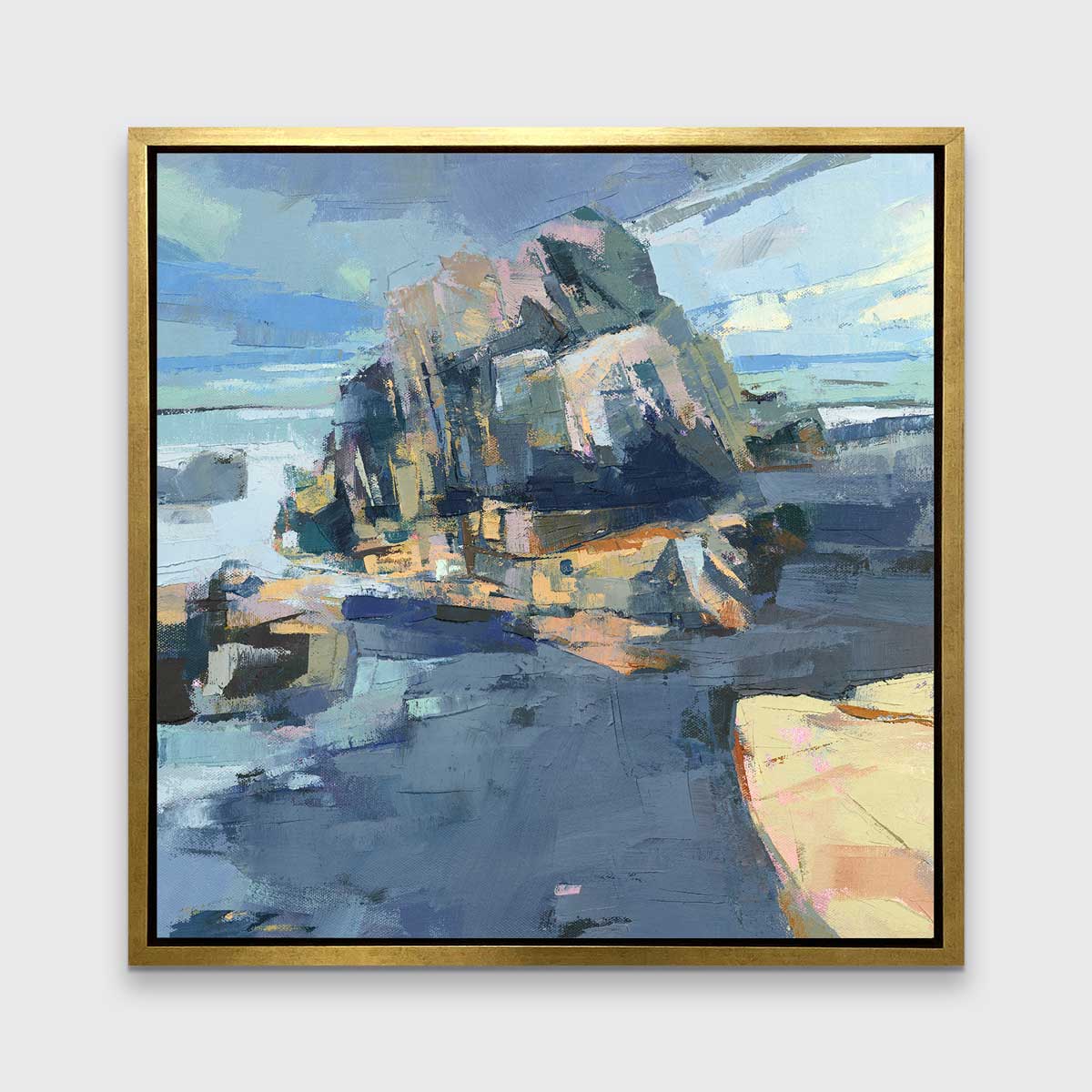 A blue, green and yellow abstract landscape print in a gold floater frame hangs on a white wall.