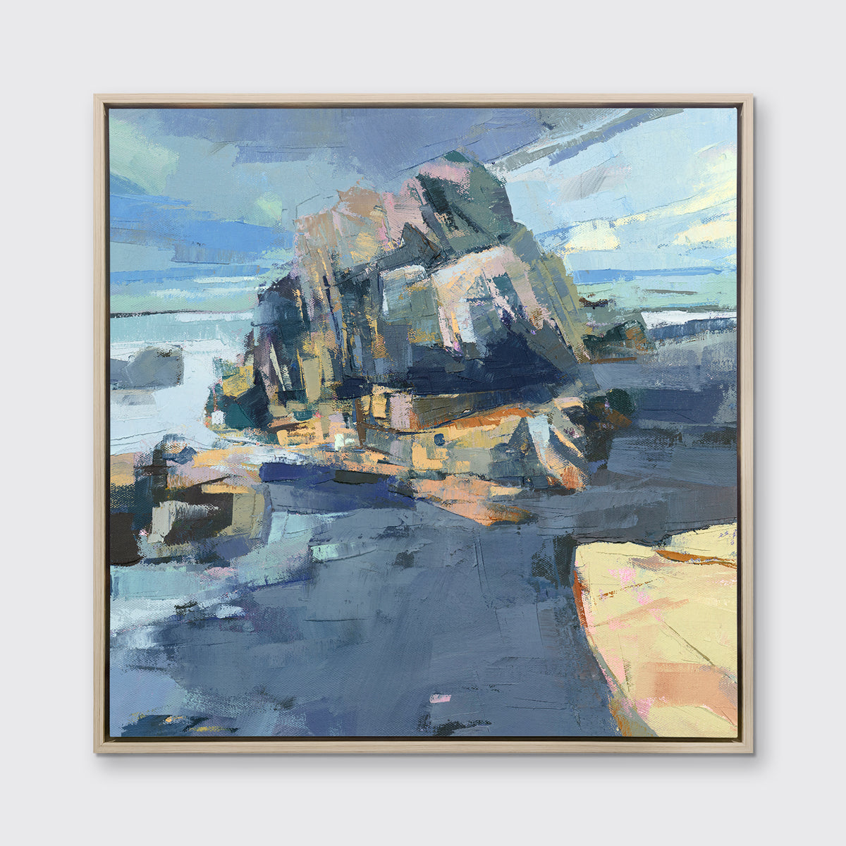 A blue, green and yellow abstract landscape print in a white oak wood floater frame hangs on a white wall.
