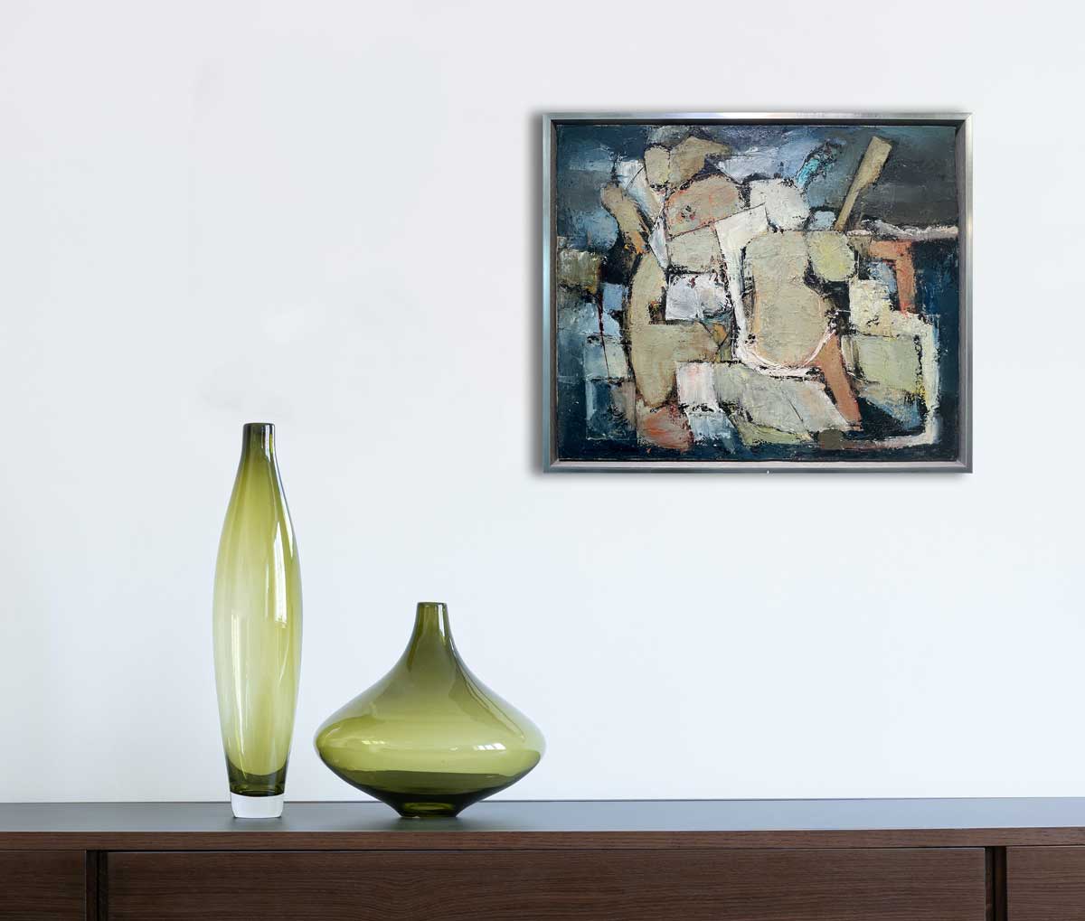 A painting of abstract human forms hangs above a wooden console table.