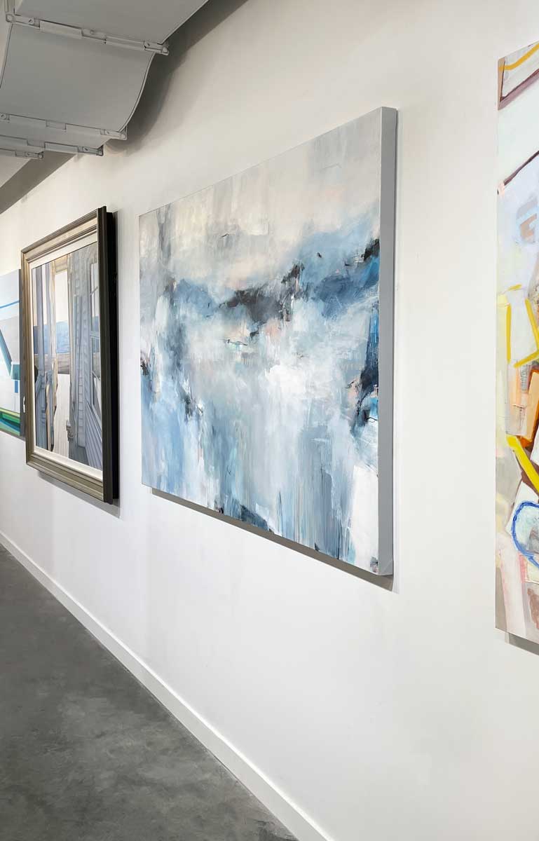 Cool toned abstract painting with spots of beige by Kelly Rossetti hangs on a white wall in the gallery, viewed from the right. 