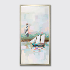 A pastel multicolored abstract landscape with a sailboat and lighthouse print in a silver floater frame hangs on a white wall.