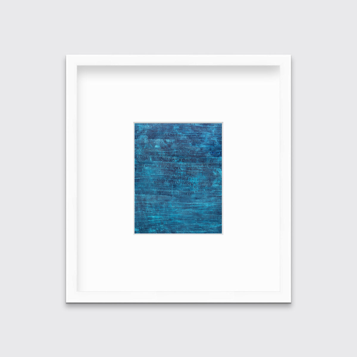 A dark teal abstract print in a white frame with a mat hangs on a white wall.