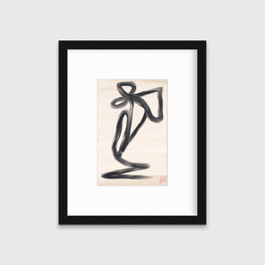 A black and beige abstract print in a black frame hangs on a light grey wall. 