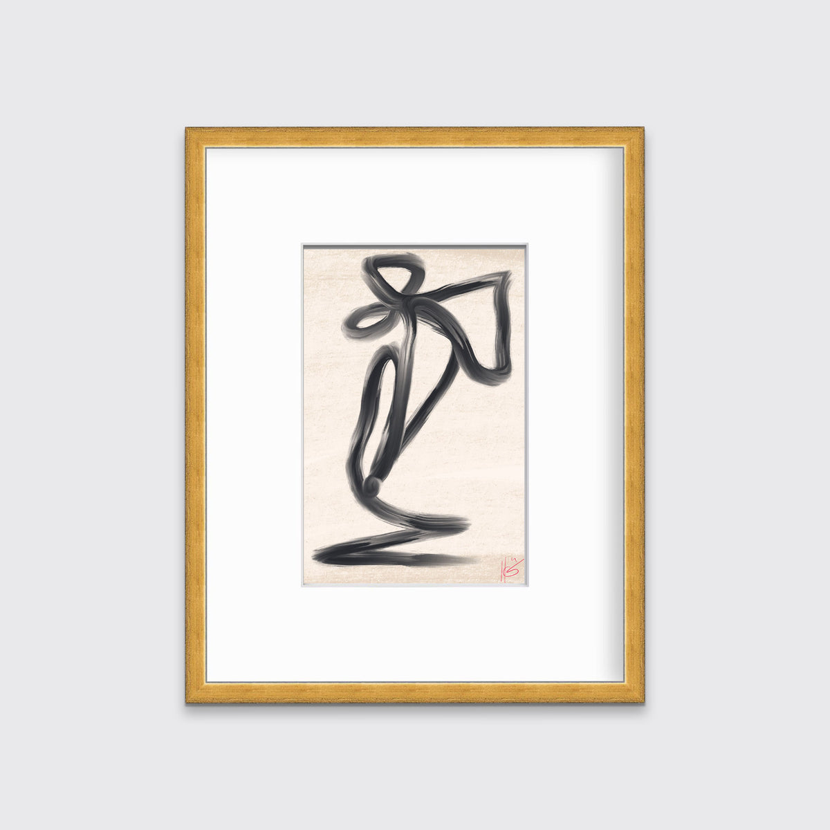 An abstract black and beige art print framed in a gold print hangs on a light grey wall. 