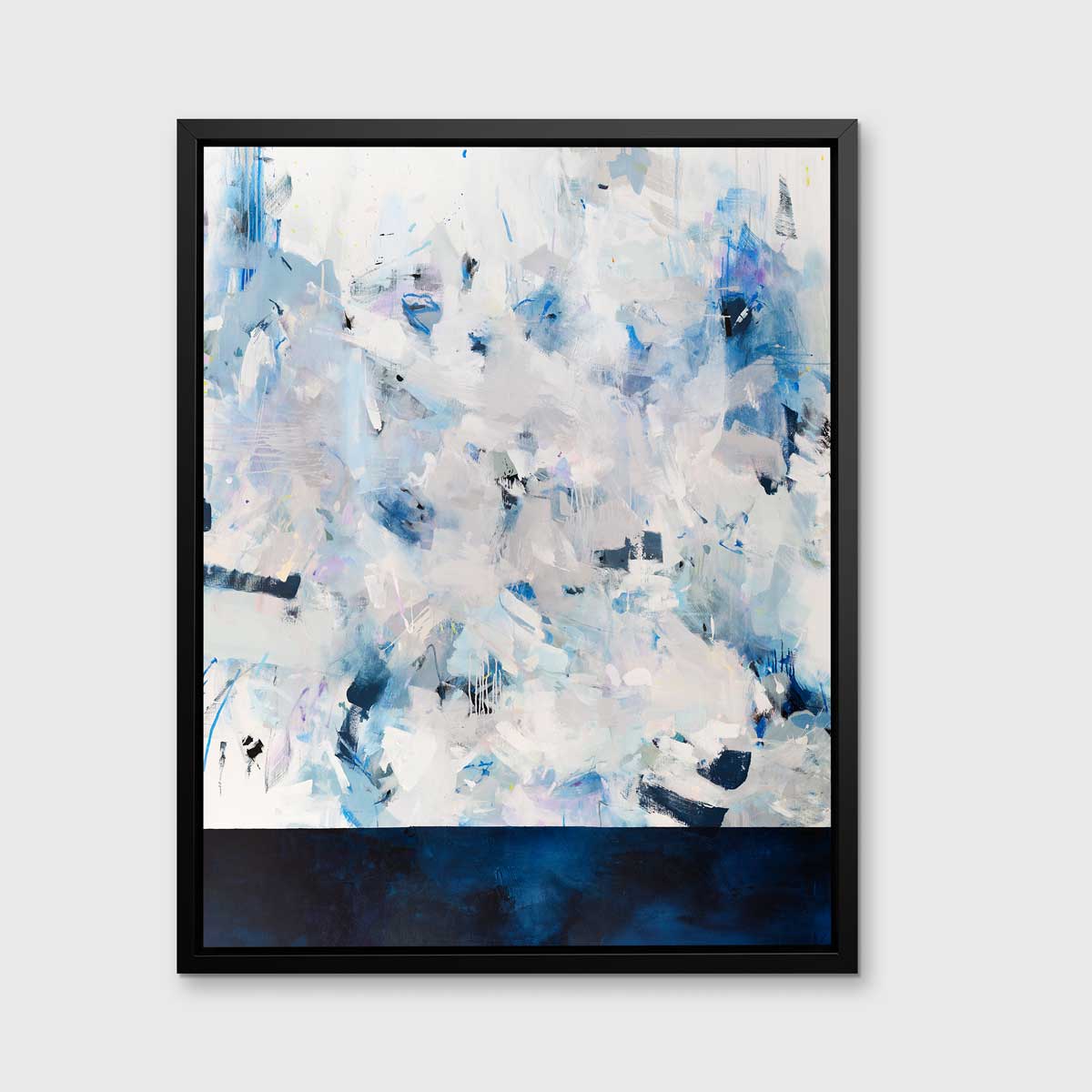 A blue, white and light grey abstract print in a black floater frame hangs vertically on a white wall.