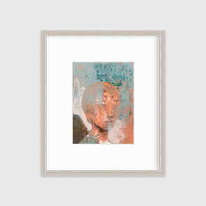 A copper, teal and beige abstract figural print in a silver frame with a mat hangs on a white wall.