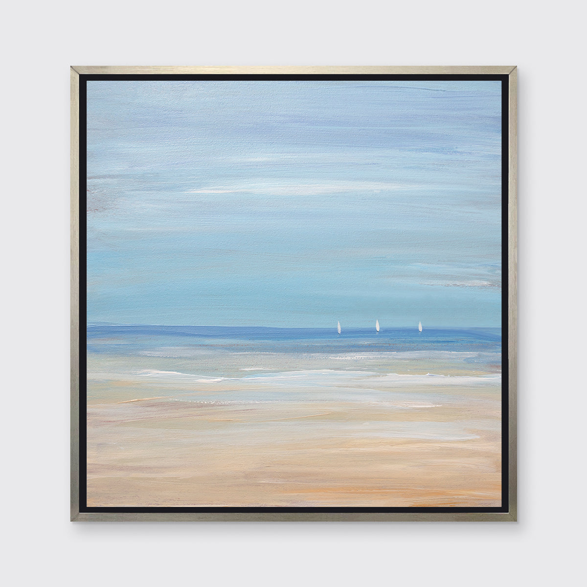 A blue, beige and white abstract seascape print with three small sailboats in a silver floater frame hangs on a white wall.
