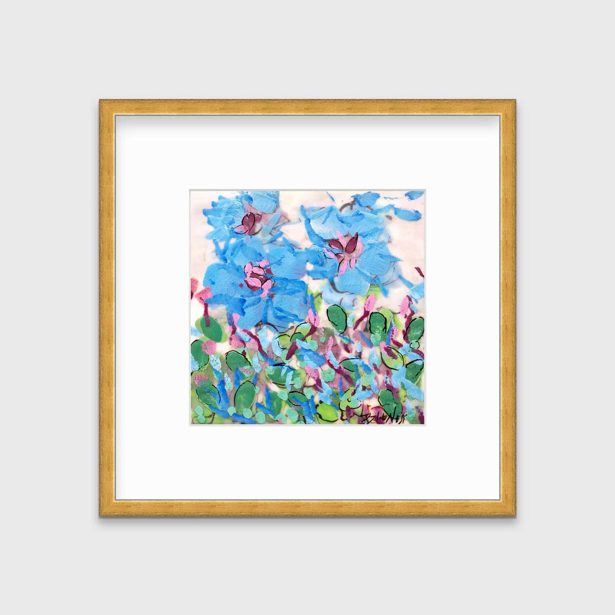 A blue, pink, green and white abstract floral print in a gold frame with a mat hangs on a white wall.
