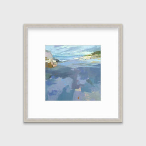 A blue, purple and green abstract landscape print in a silver frame with a mat hangs on a white wall.
