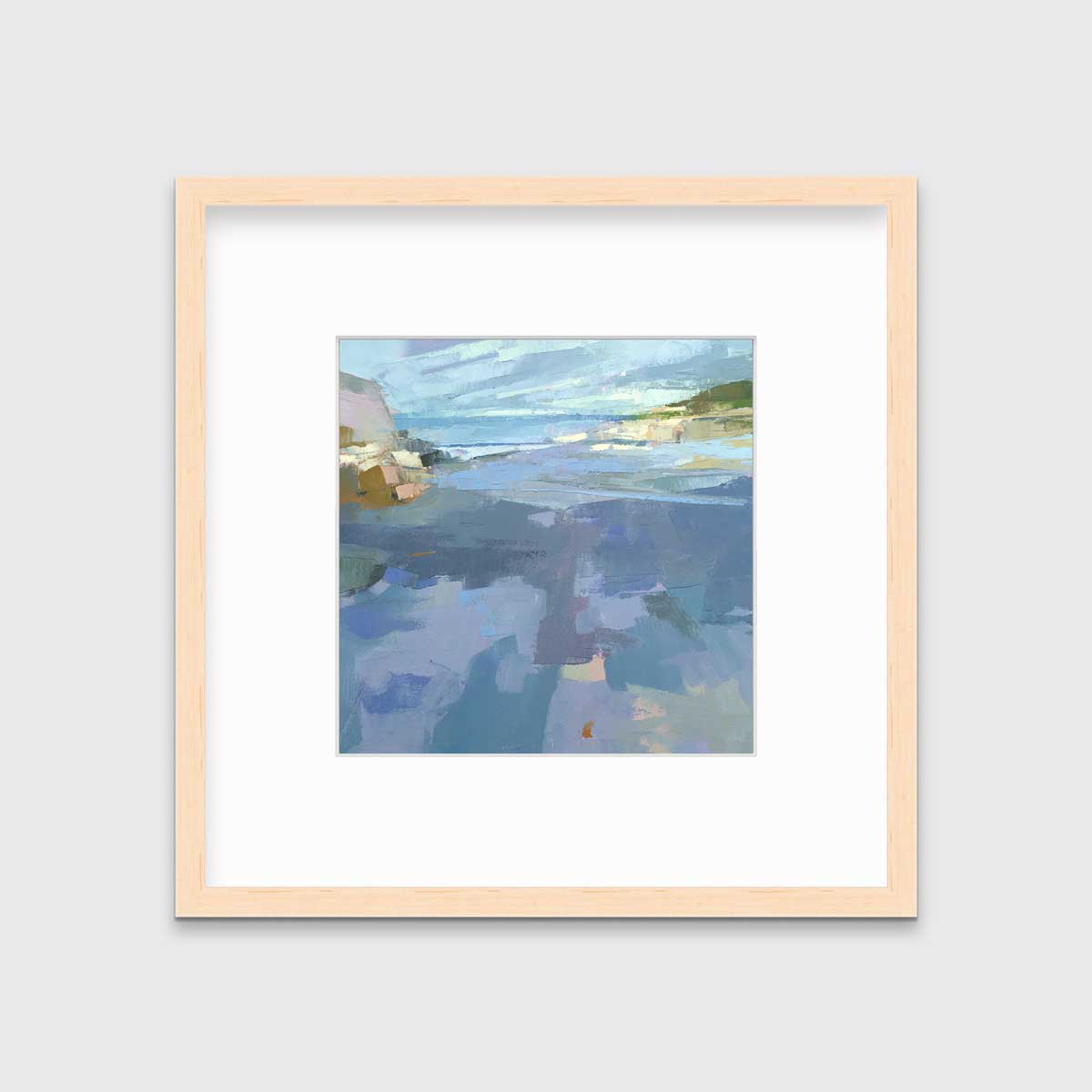 A blue, purple and green abstract landscape print in a natural wood frame with a mat hangs on a white wall.