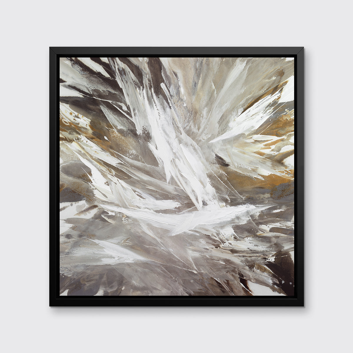 A white, grey, dark grey and gold abstract print in a black floater frame hangs on a white wall.