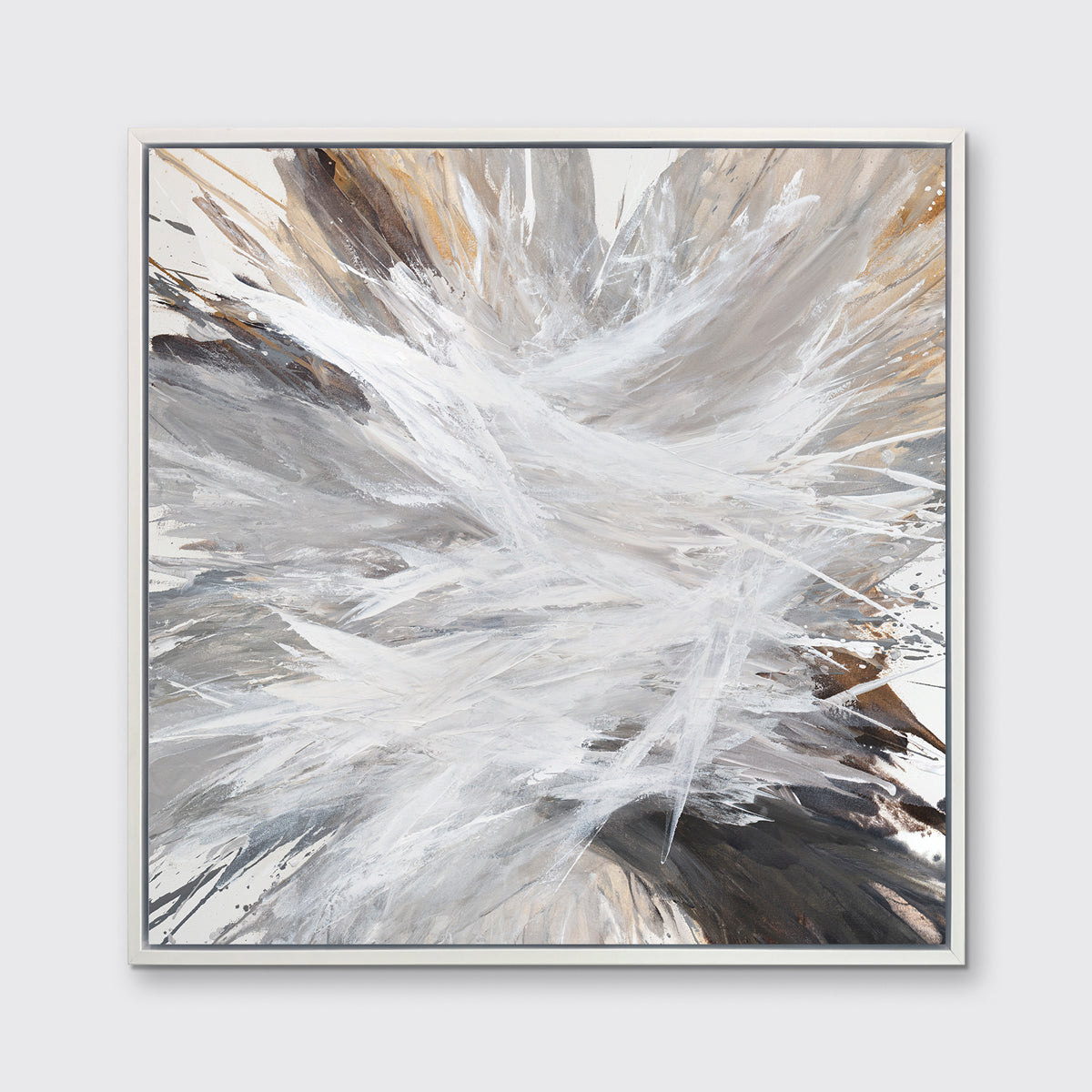 A white, grey, dark grey and gold abstract print in a white floater frame hangs on a white wall.