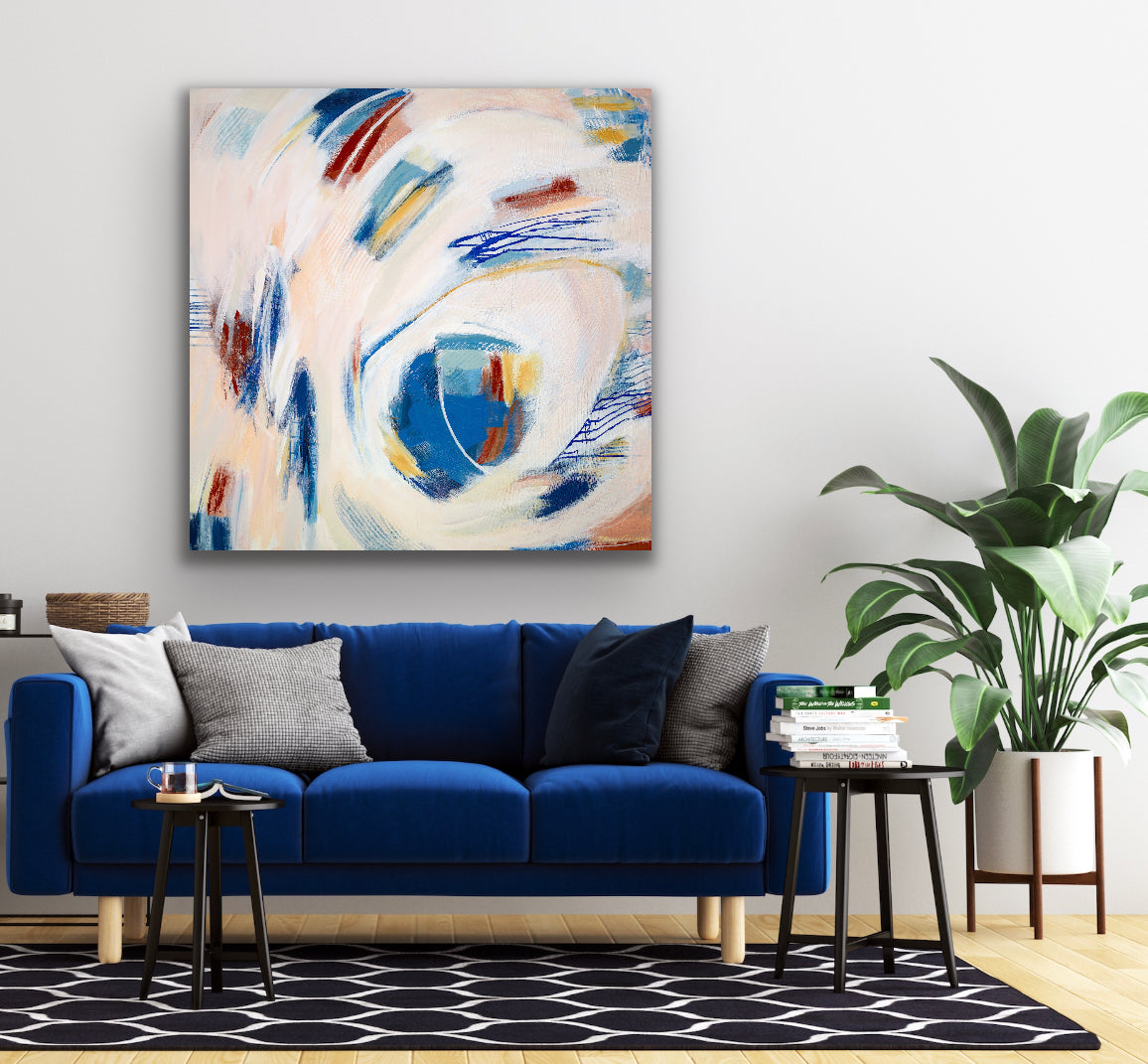 Mary Gaspar's painting, Touch, hanging on a white wall above a dark blue couch.