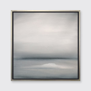 A tonal grey print in a silver floater frame hangs on a white wall.