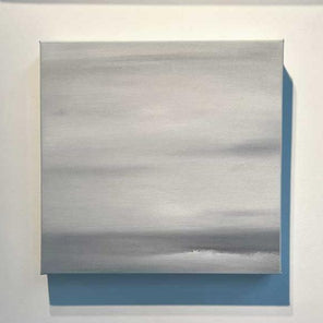 A tonal grey abstract painting by Tony Iadicicco hangs on a white wall.