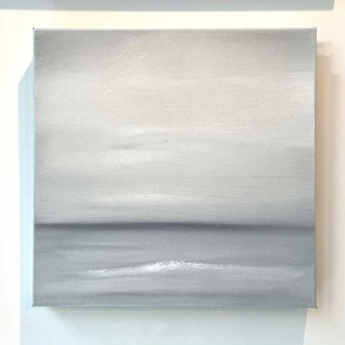A tonal grey and white abstract painting by Tony Iadicicco hangs on a white wall.