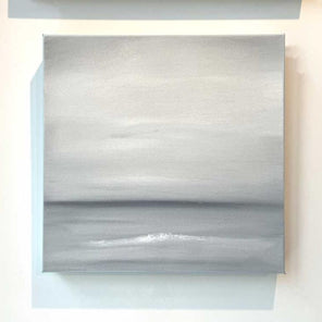 A tonal grey and white abstract painting by Tony Iadicicco hangs on a white wall.