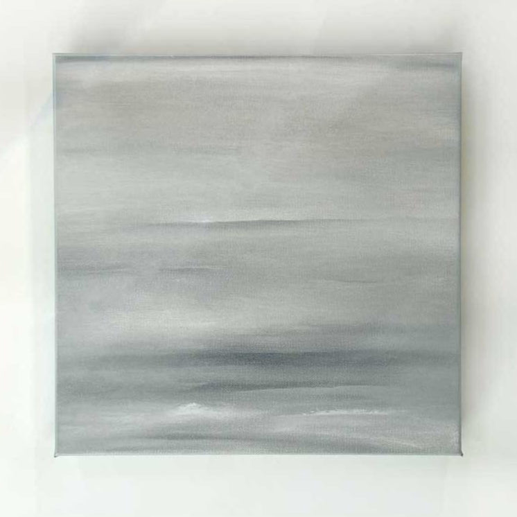A tonal grey abstract painting by Tony Iadicicco hangs on a white wall.