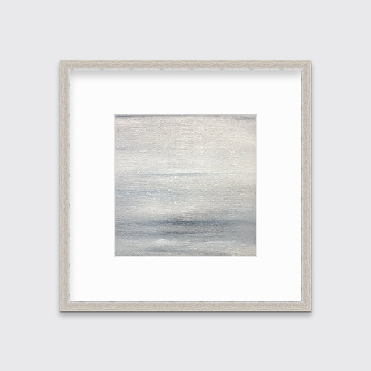 A tonal grey abstract print in a silver frame with a mat hangs on a white wall.