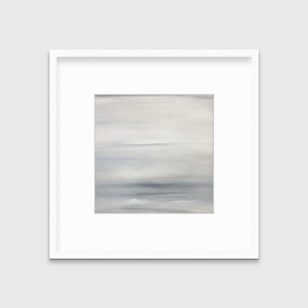 A tonal grey abstract print in a white frame with a mat hangs on a white wall.