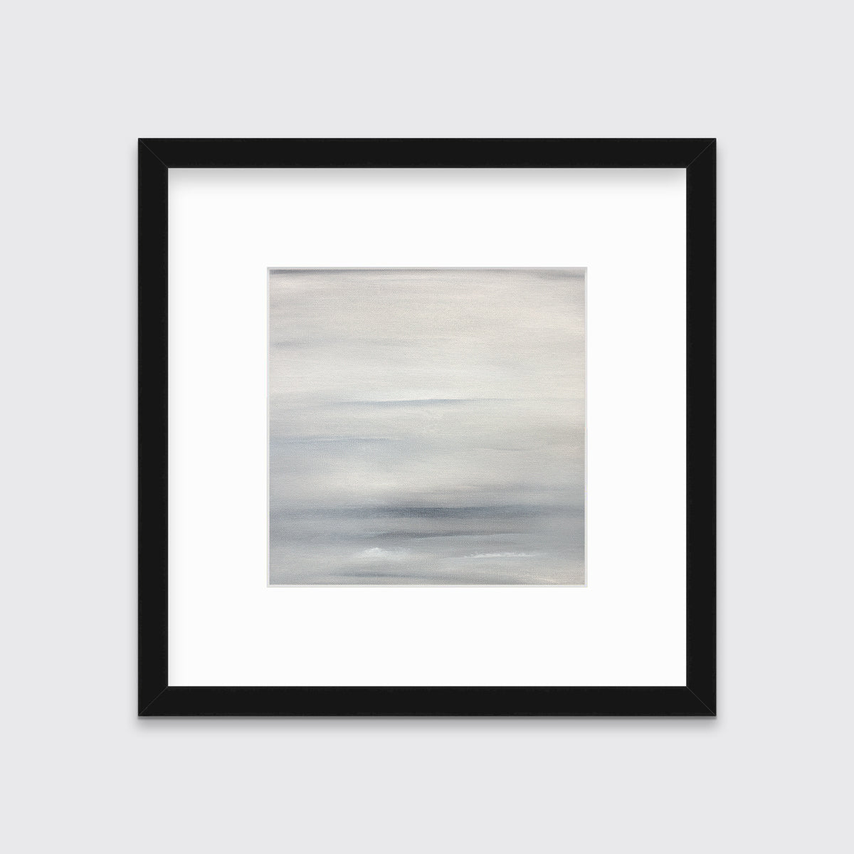 A tonal grey abstract print in a black frame with a mat hangs on a white wall.