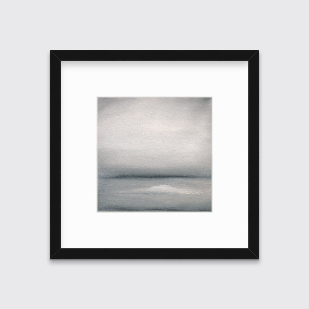 A tonal grey abstract print in a black frame with a mat hangs on a white wall.