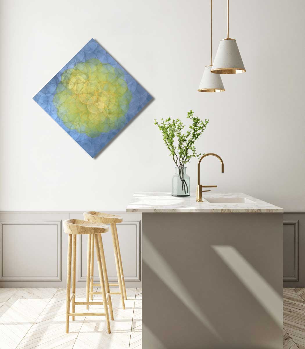 A blue and yellow abstract geometric painting hung on a white wall above a white marble kitchen countertop with natural wood bar stools. 
