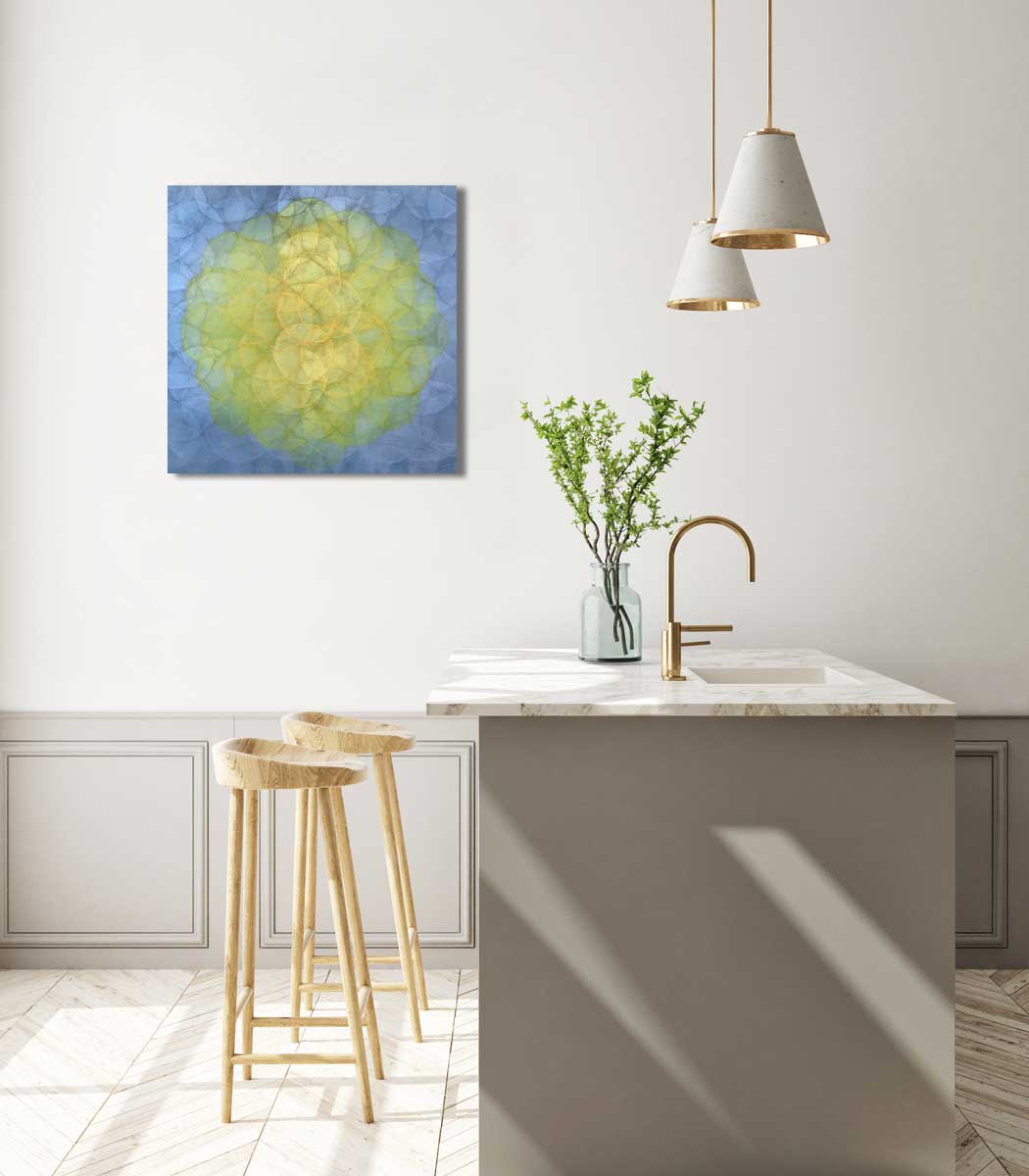 A blue and yellow abstract geometric painting hung on a white wall above a white marble kitchen countertop with natural wood bar stools.