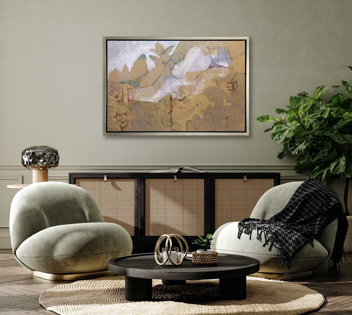 A dark gold and grey abstract print in a silver floater frame hangs on a light green wall above a black and rattan cabinet, two modern light green and gold chairs and a black round coffee table.