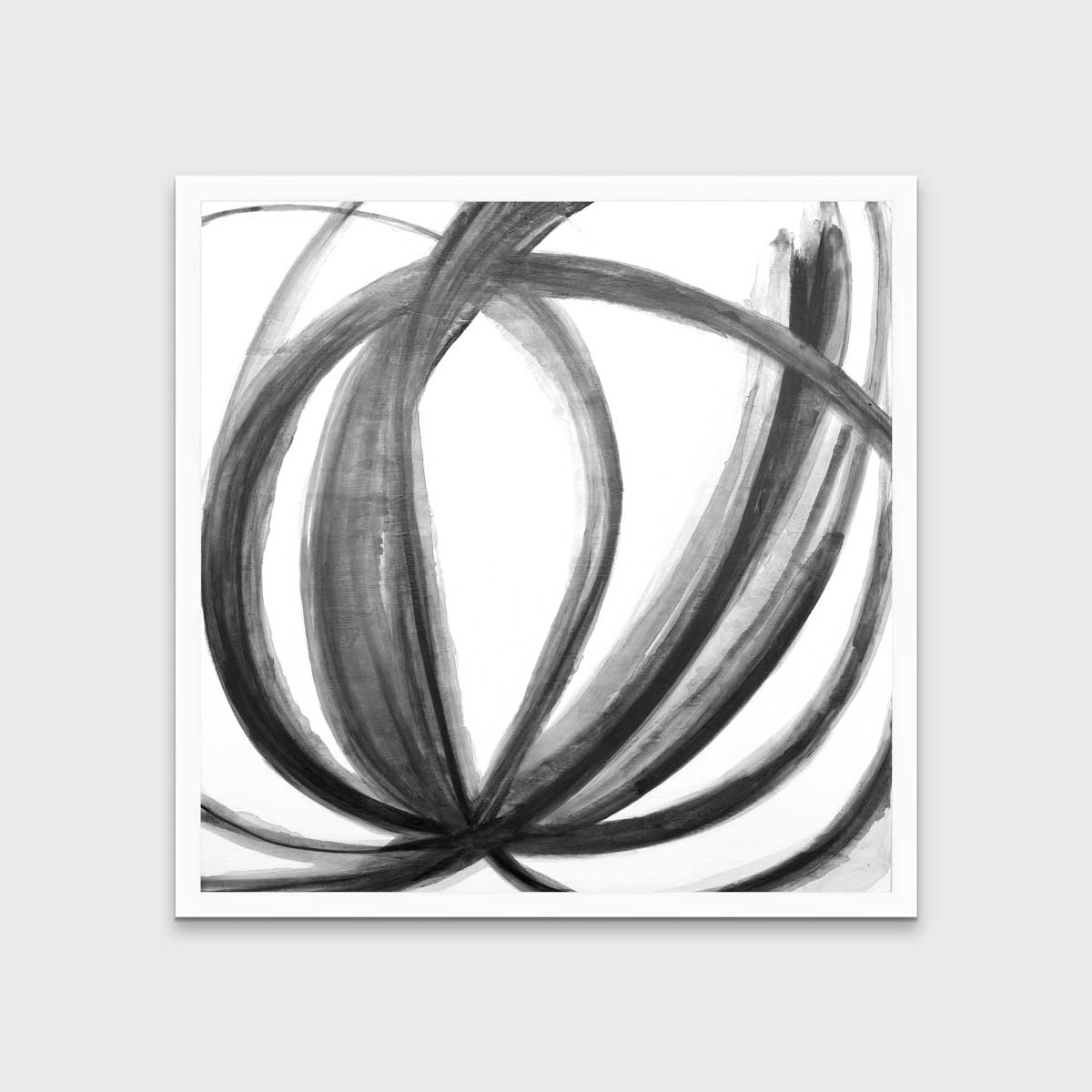 A black, grey and white abstract print in an unmatted white frame hangs on a white wall.