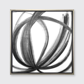 A black, grey and white abstract print in a silver floater frame hangs on a white wall.