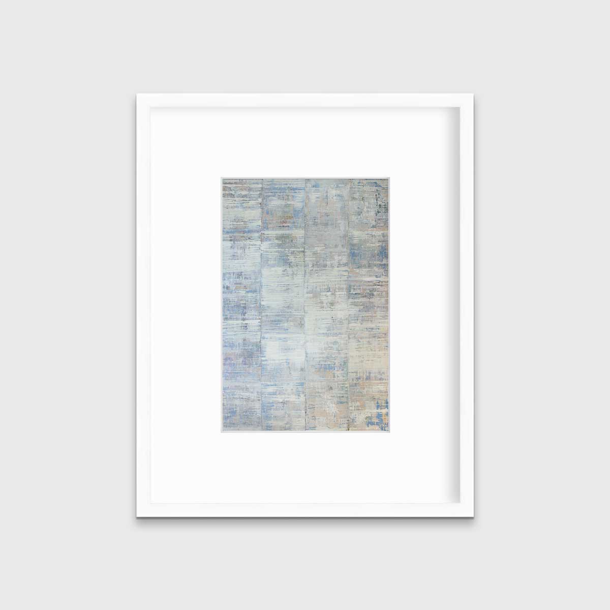 A white and blue abstract print in a white frame with a mat hangs on a white wall.