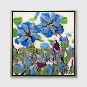 A blue, green and white abstract floral print in a silver floater frame hangs on a white wall.