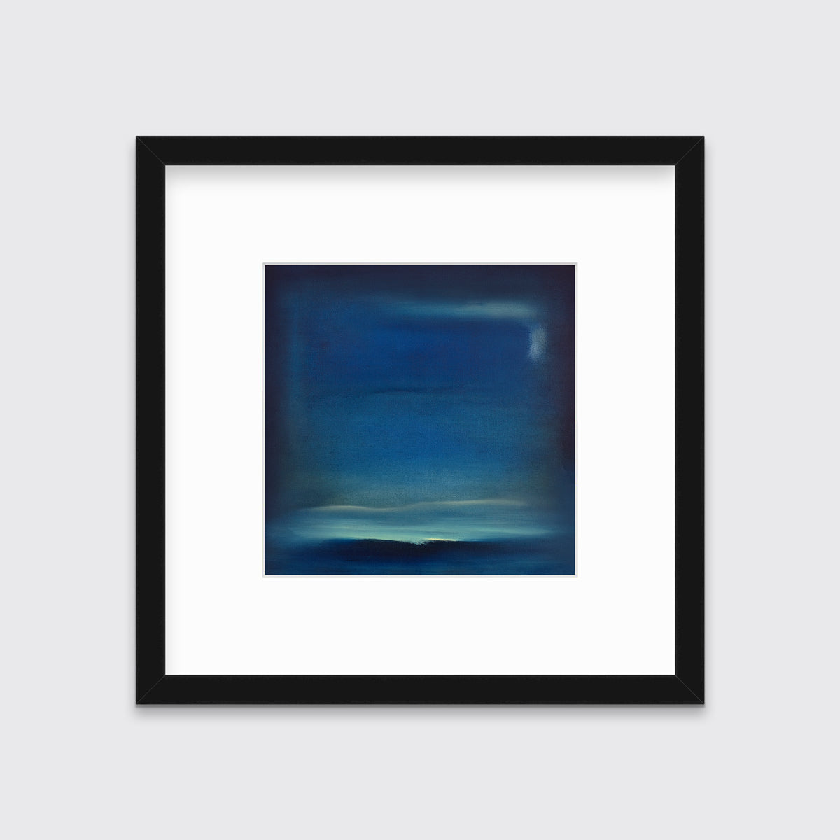 A dark blue and teal with accents of light yellow abstract print in a black frame with a mat hangs on a white wall.