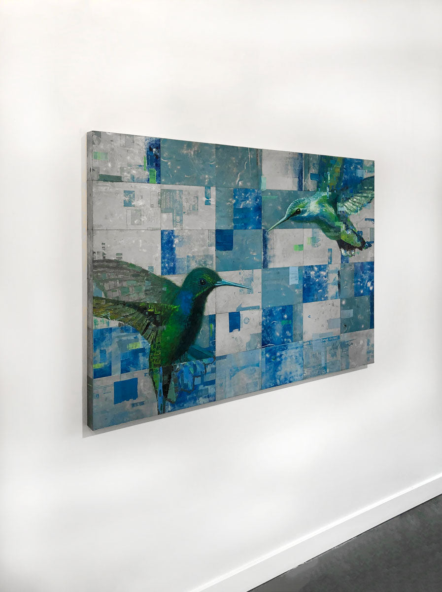 A left-side angle of an abstract painting of two humming birds by Ned Martin, on a white wall.